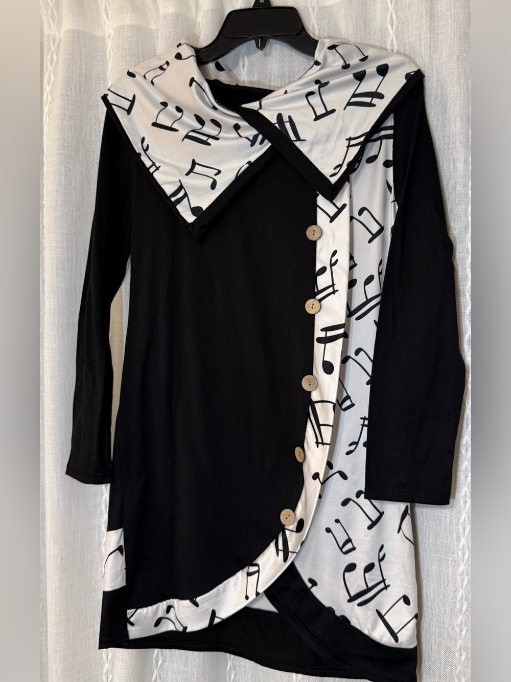 Musical note tunic pullover top with faux buttons.